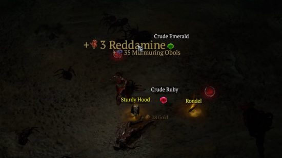 Reddamine, uno de los recursos de Diablo 4, y otros objetos valiosos, yacen en el suelo tras haber sido encontrados en un cofre.